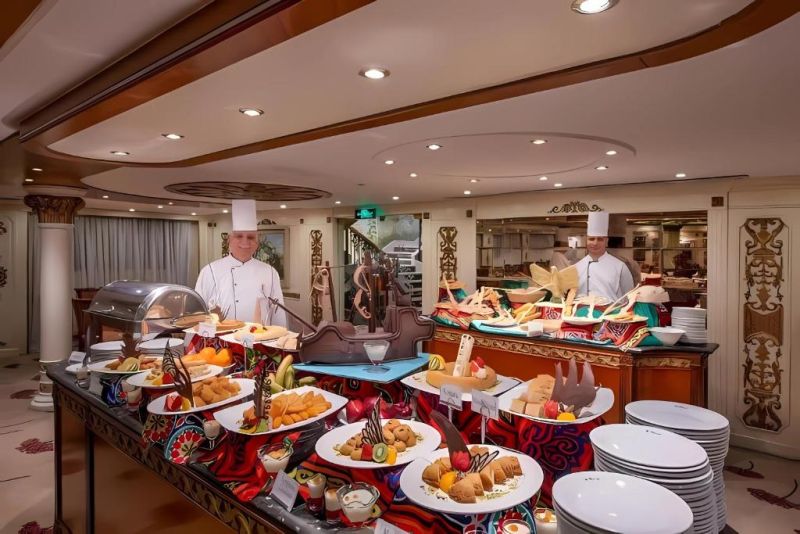 Cairo Dinner Cruise guests sailing by illuminated monuments on Cairo's Nile